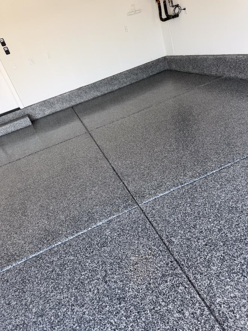 Heavy-duty grey flake industrial epoxy floor with coated stem wall