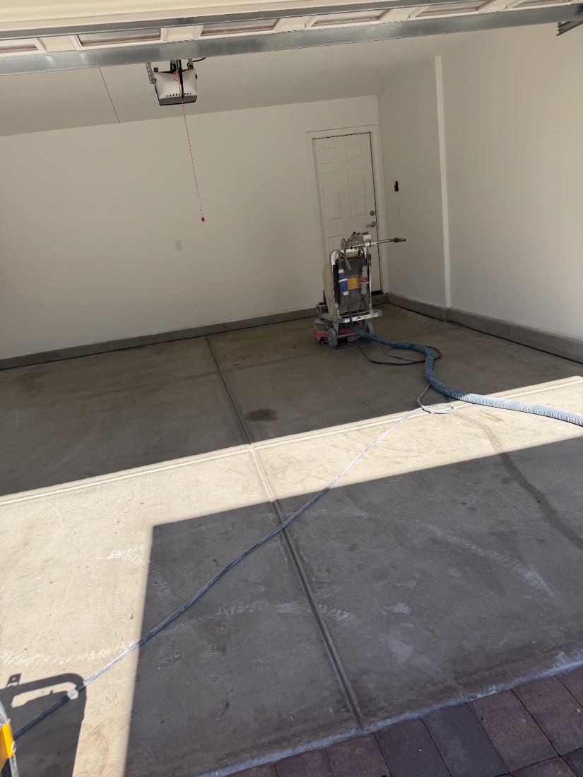 Before: bare concrete garage floor being diamond ground